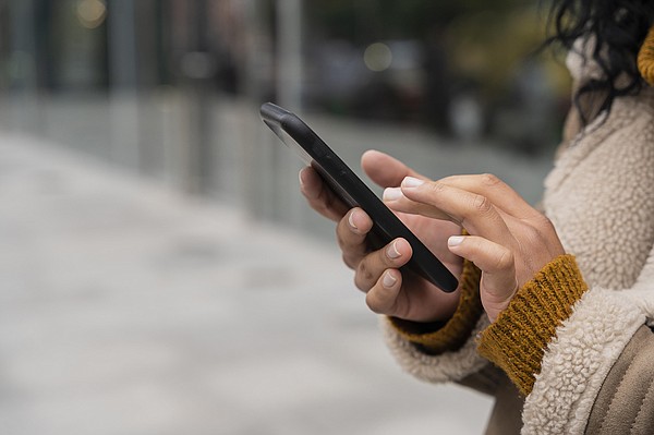 VP woman using her smartphone outside with copy space_t600